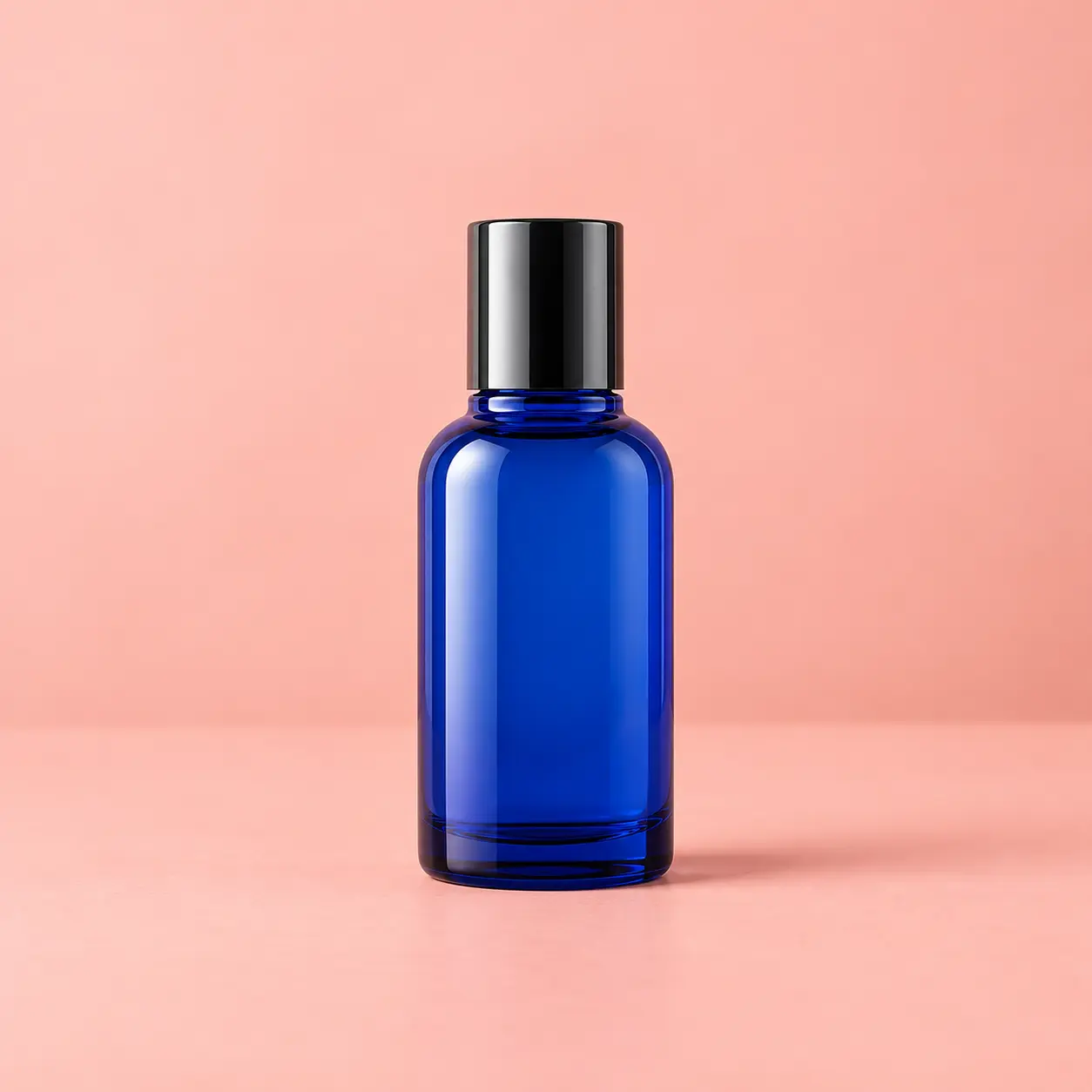 Blue product bottle placed on a coordinated pale coral background color with natural shadows