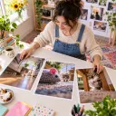 Meme creator arranging printed cat-vision scenes on a bright studio table