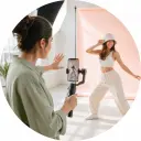 Short video creator directing a vertical dance scene on a bright daylight studio set