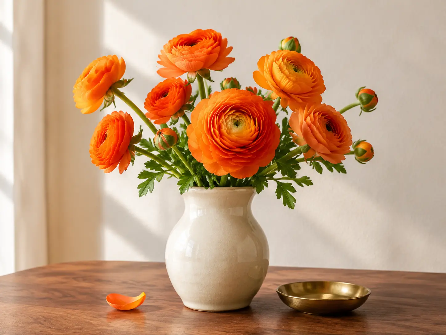 A warm still life of orange flowers and a ceramic vase on a wooden table