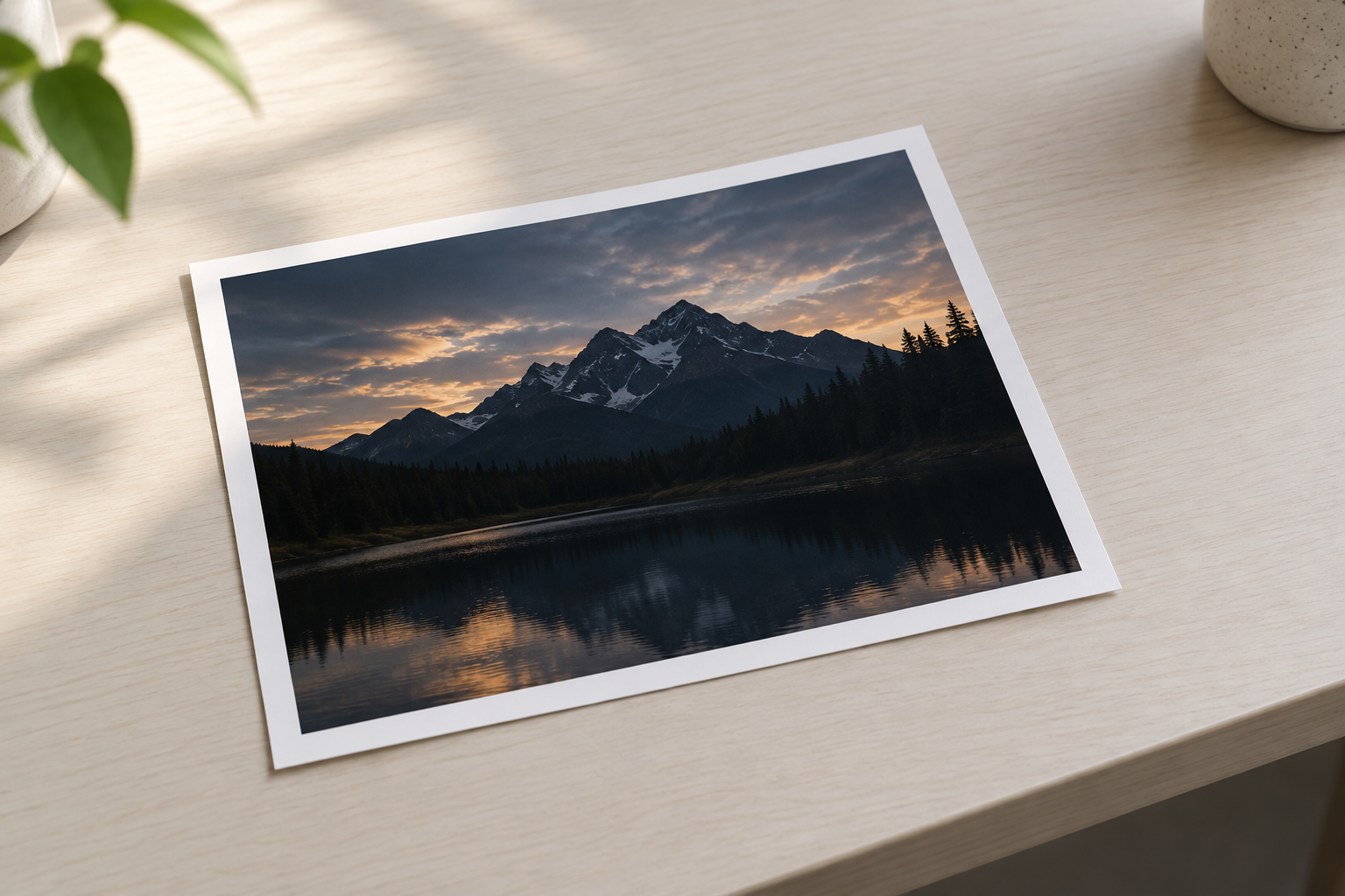 A dark photo print lying alone on a pale desk in soft daylight