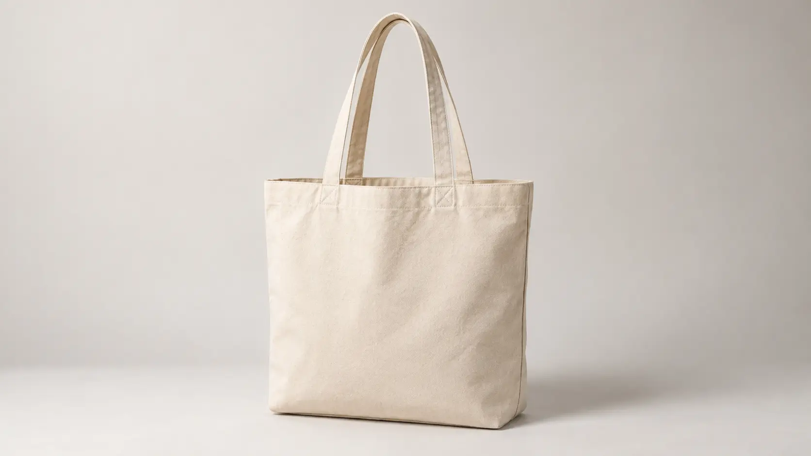 Unbranded canvas bag photographed in a clean studio setting with coherent shadows