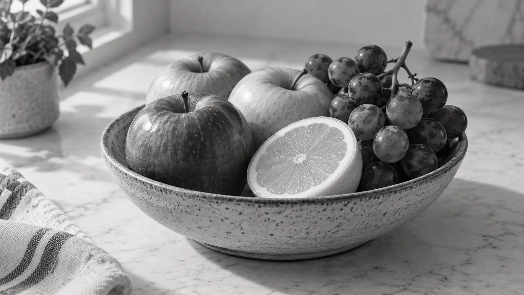 A fruit bowl showing rich reds and greens mapped to distinct greys in the converted image