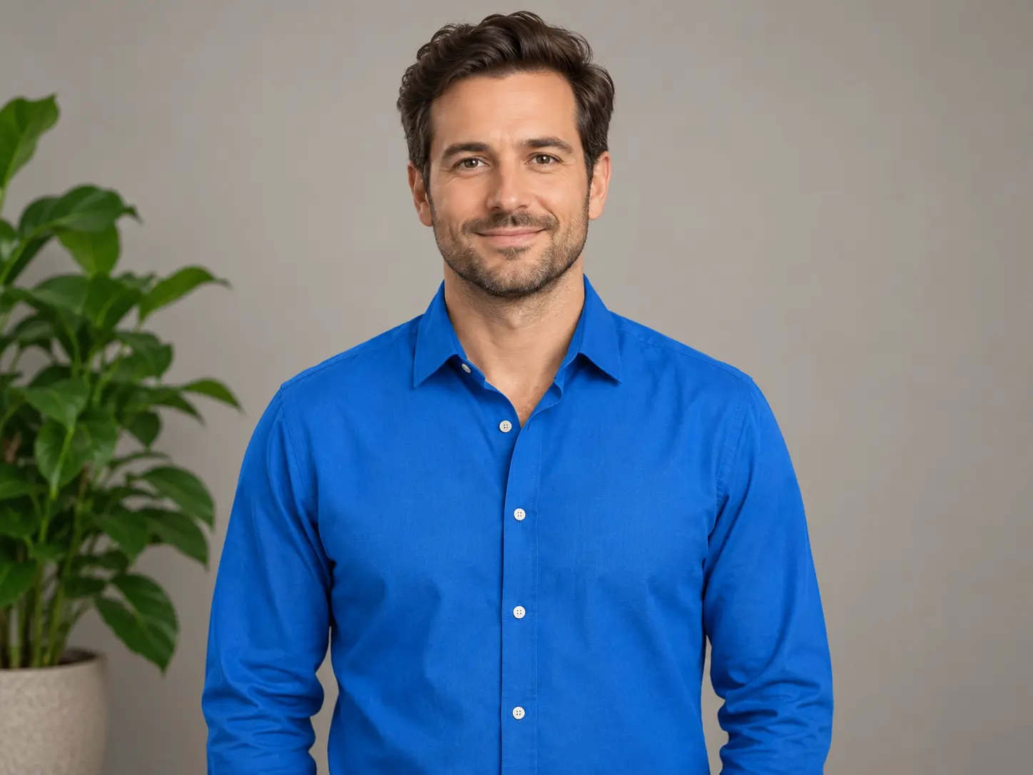 A full colour portrait of a man in a blue shirt before the photo is converted to black and white