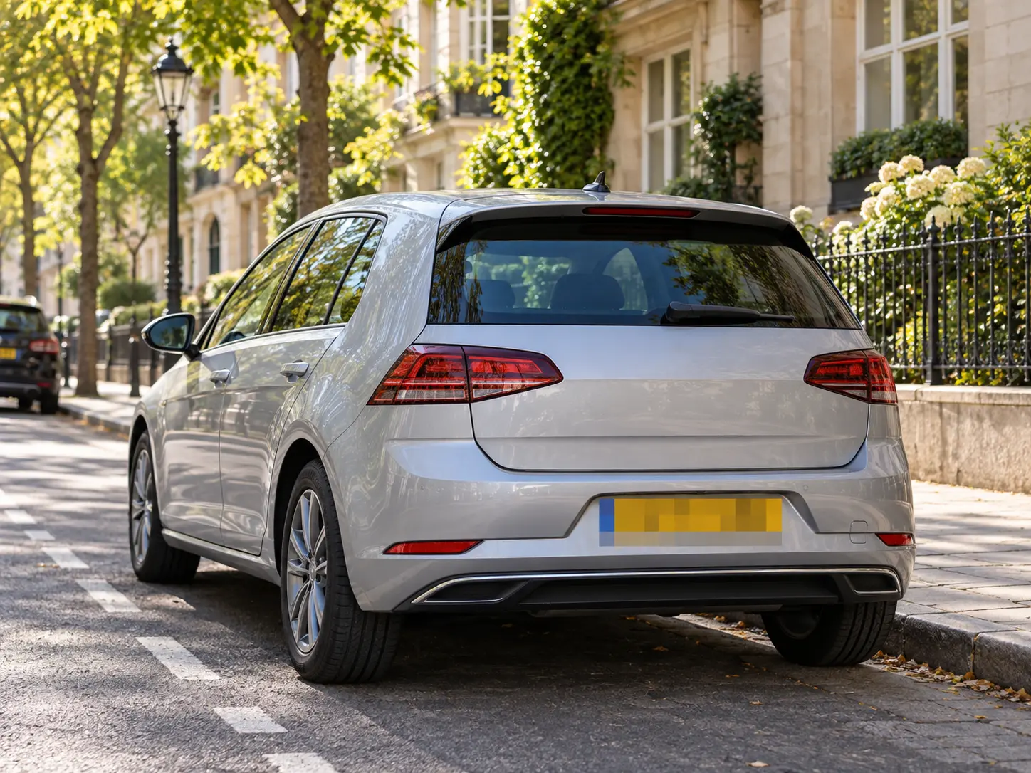 Street photo with a license plate covered by strong square pixel blocks while the rest stays sharp