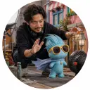 Freelance producer directing a miniature comic mascot scene with practical props