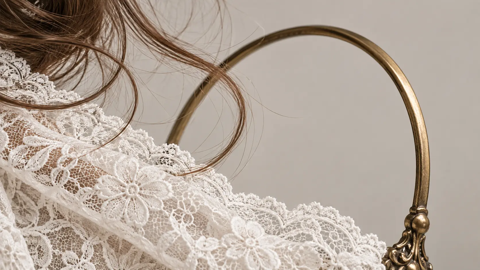 Close view of loose hair, lace, and a thin handle isolated with clean edges