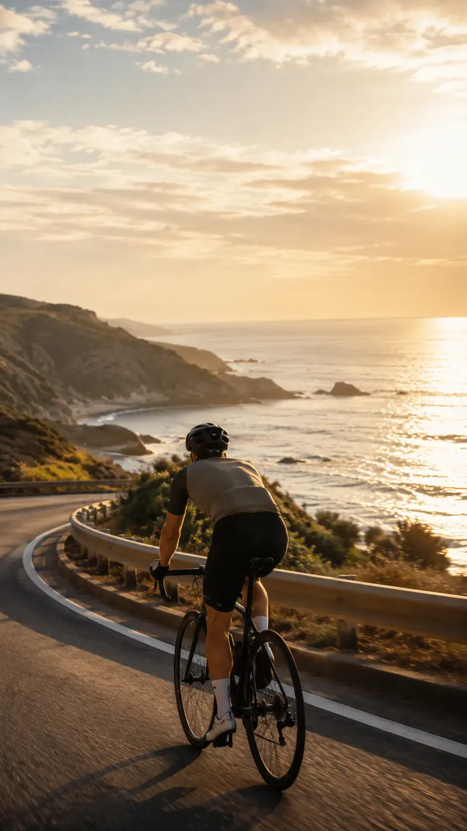 Vertical travel clip frame of a cyclist on a bright coastal road