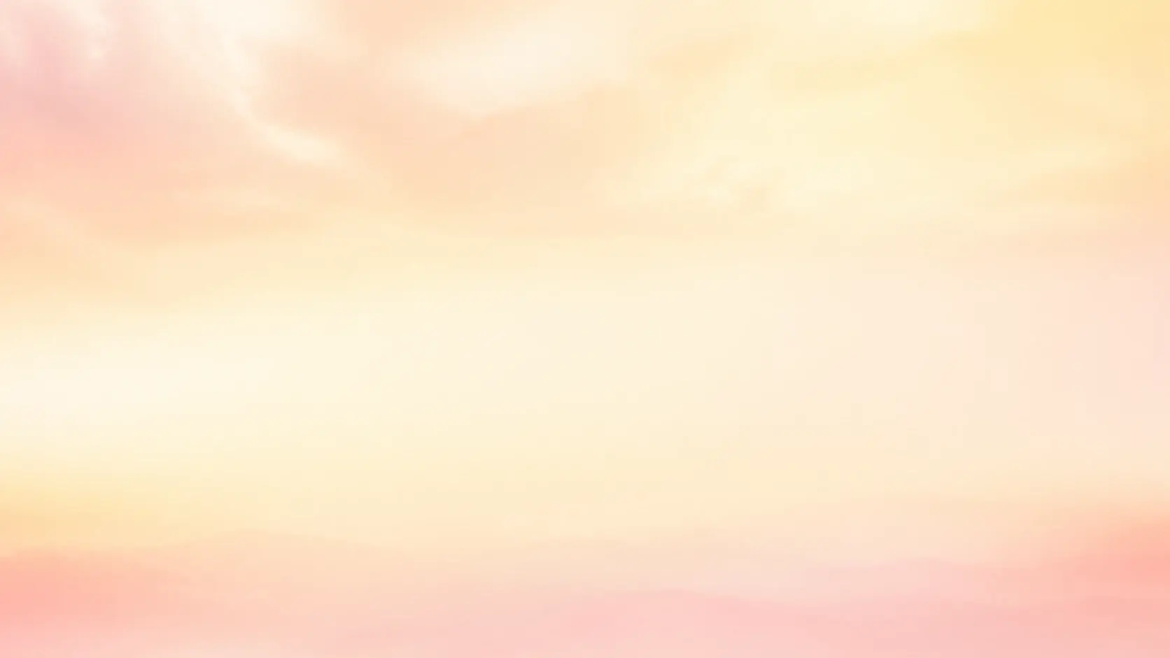 A wide pale horizon dissolved into a calm dreamy haze with soft warm light across the frame
