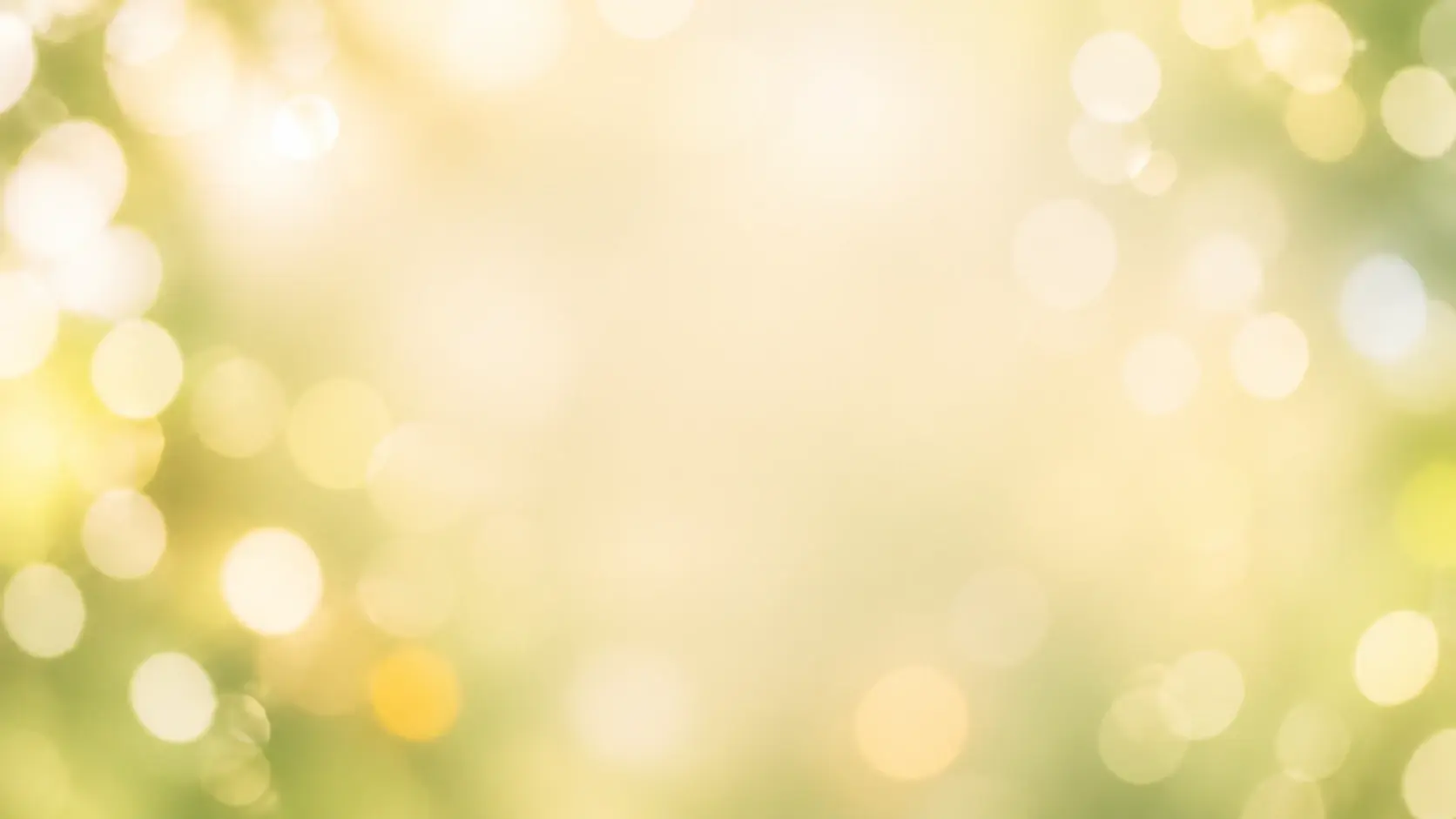 A wide field of soft out of focus daylight circles drifting across a warm pale backdrop