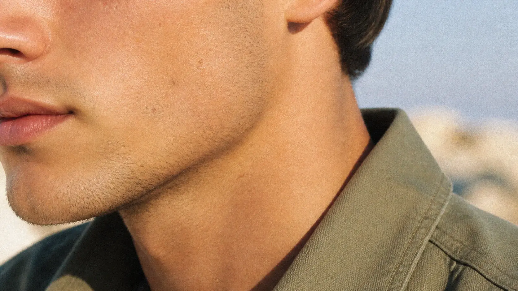 Close-up of a face showing tones preserved with a fine grain effect resting over the surface