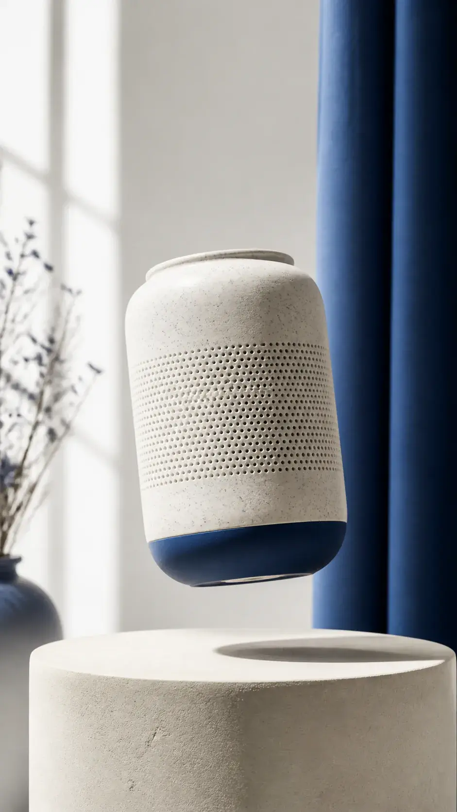 Vertical video still of a ceramic speaker turning on a bright studio plinth with soft camera motion