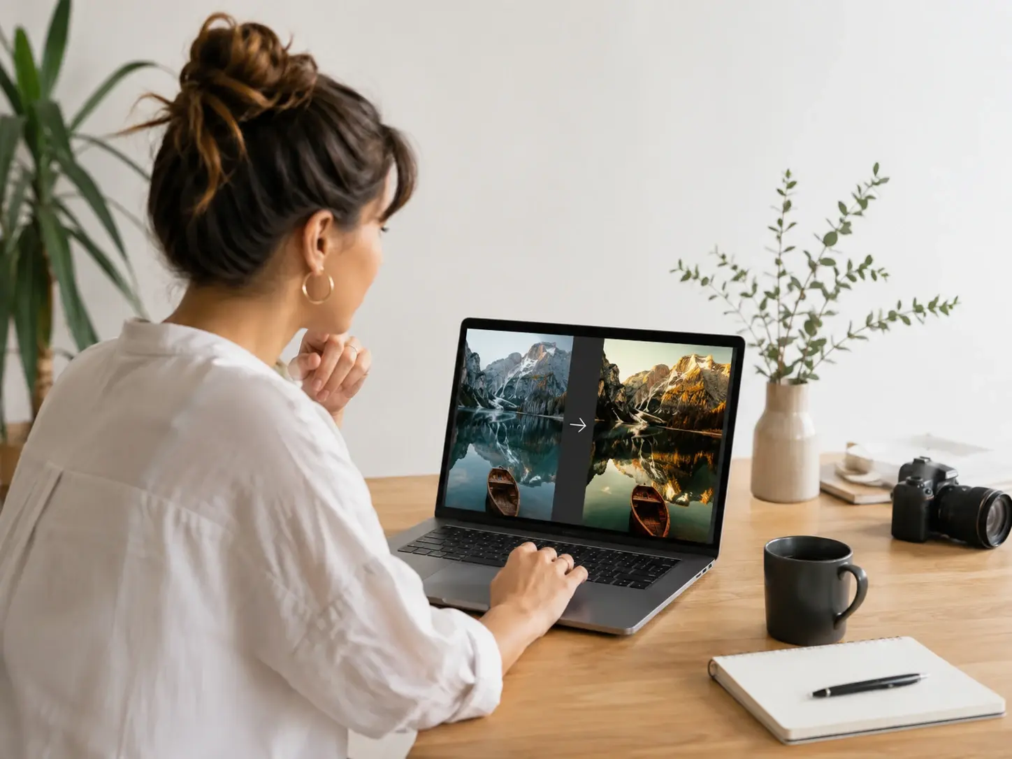 Freelance creative adjusting client photos against a reference image on a laptop