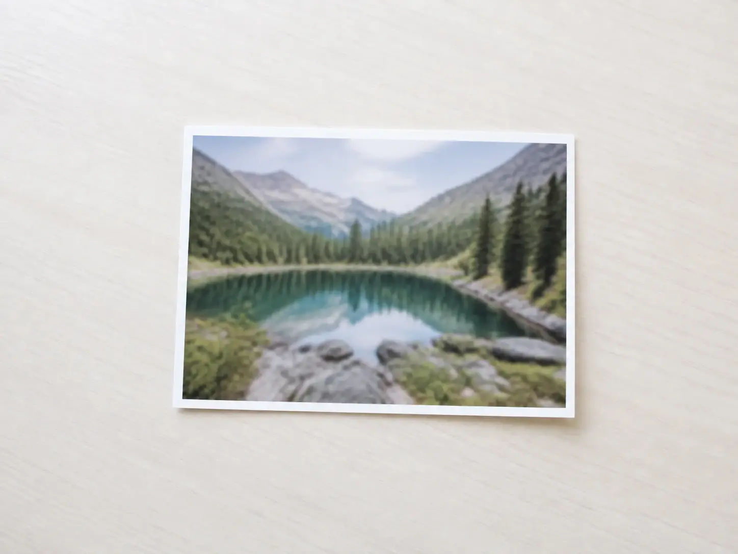 A small soft photograph of a mountain lake before it is enlarged