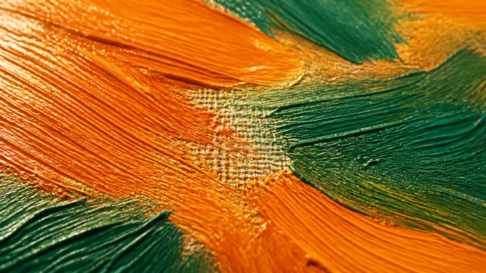 Extreme close up of ridged oil paint where brush direction and canvas weave both show clearly